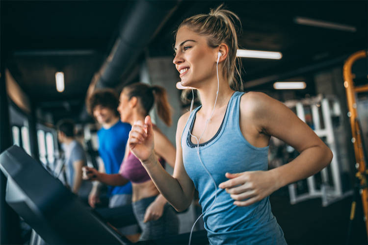 Image of a lady running on a treadmill.