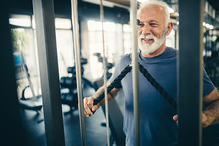 Picture of a retired man keeping fit at the gym.