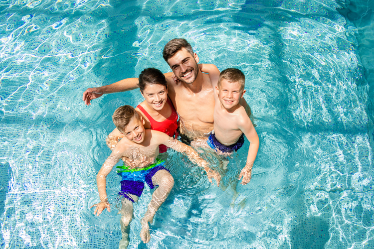 Image of a family of 4 in a swimming pool.