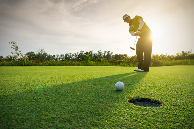 Image of a man playing golf