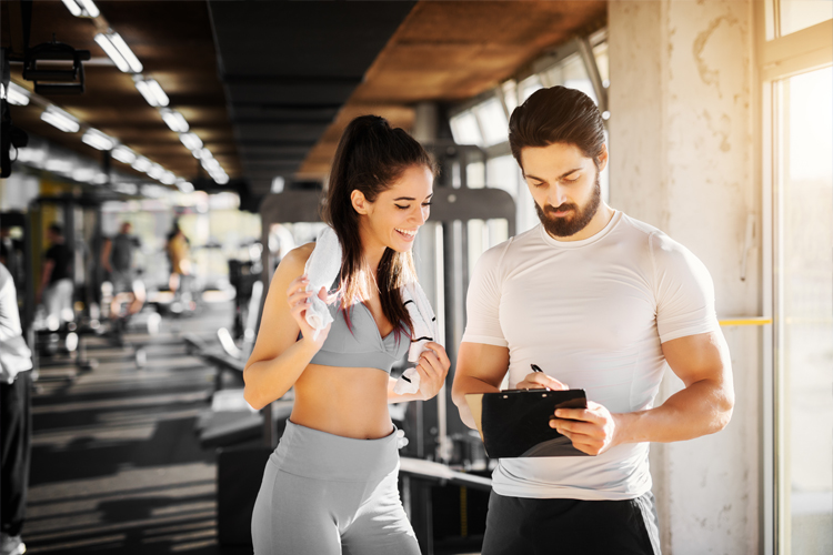 Image of a personal trainer and client at the gym.