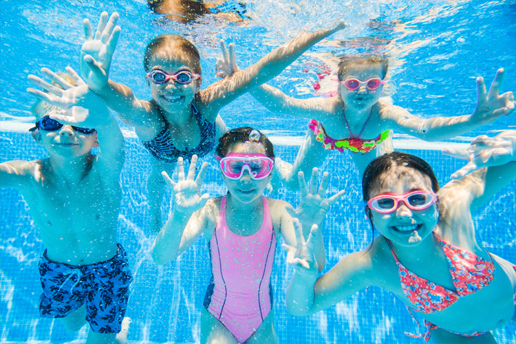 Children swimming underwater.